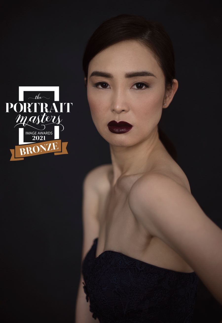 Asian woman wearing dark lipstick